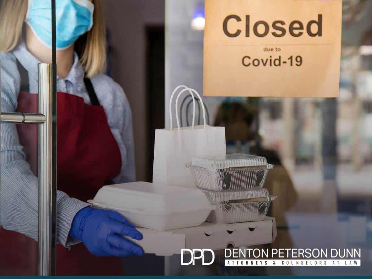 Woman waiter in protective medical mask working in a Arizona franchise business during covid-19.