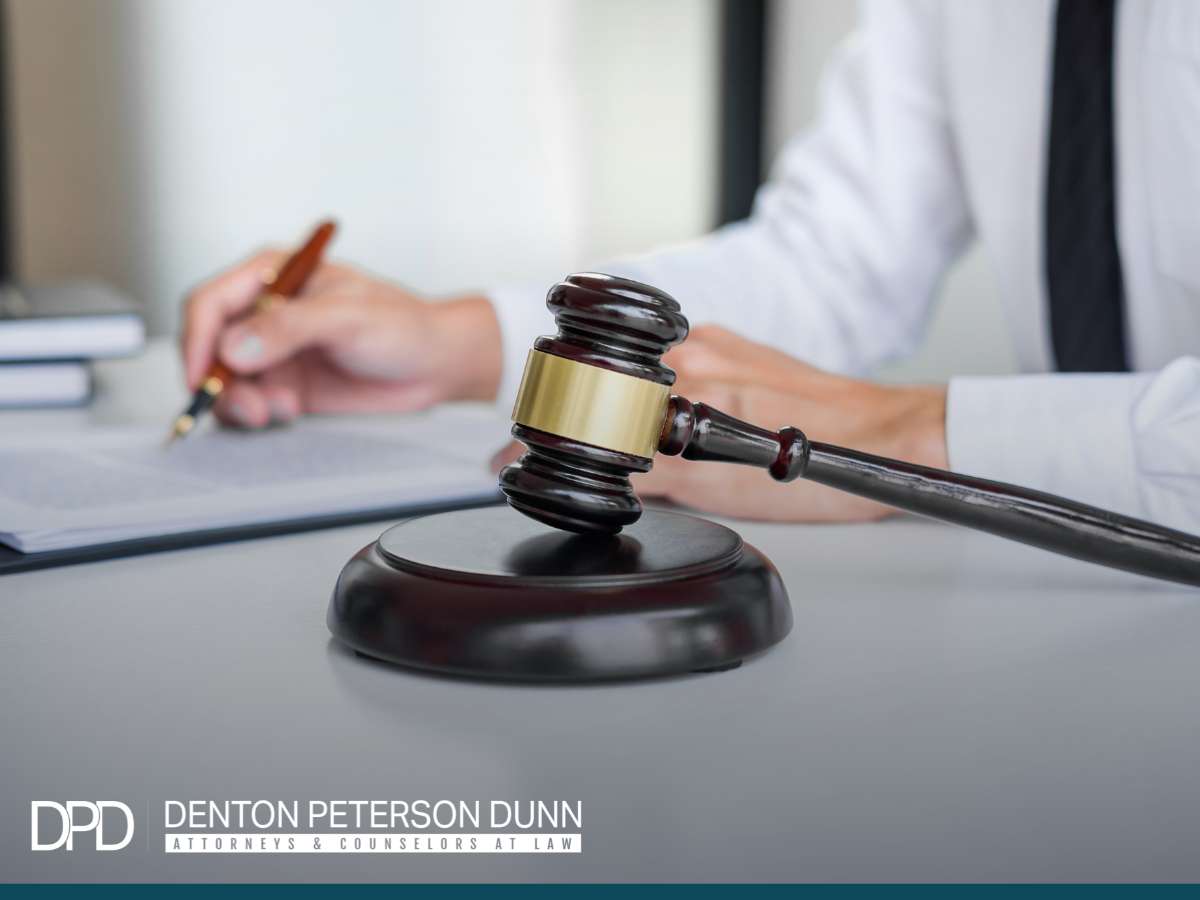 Denton Peterson Dunn attorney resolving a Commercial Property Dispute in an office setting, gavel on desk