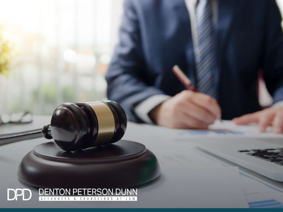 Franchise litigation lawyer working, gavel on table symbolizing legal authority at Denton Peterson Dunn