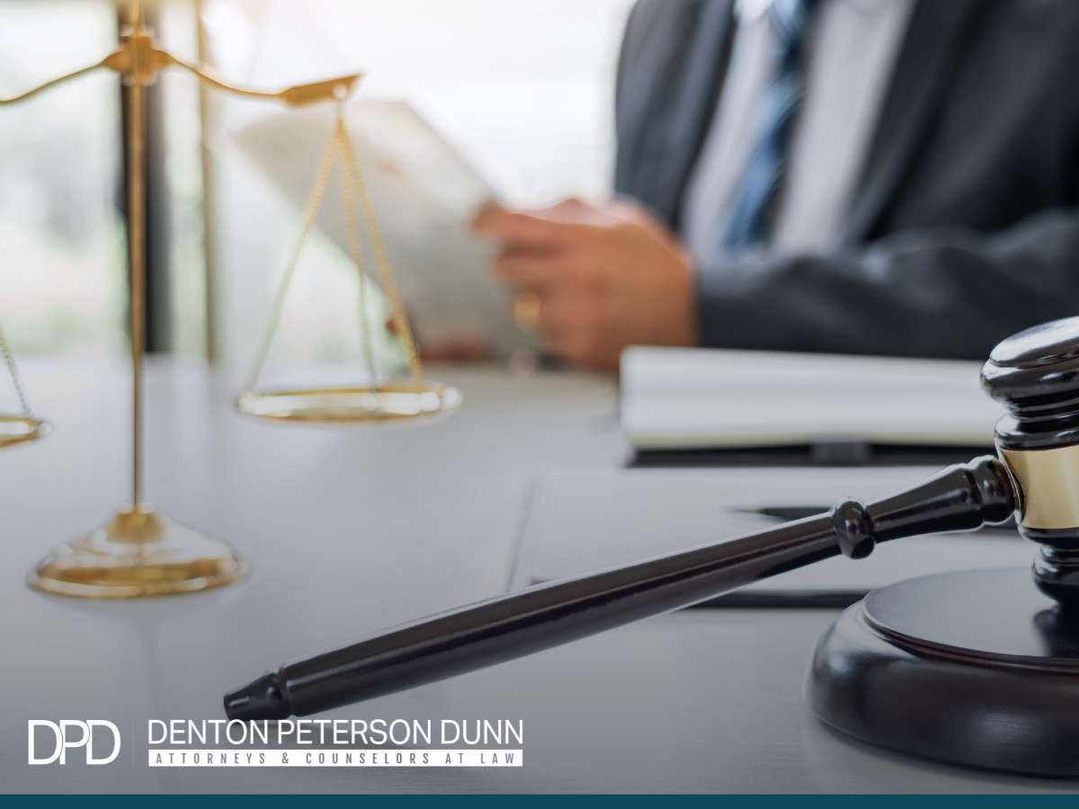 Attorney reviewing legal documents related to Partnership Strategies at Denton Peterson Dunn law firm