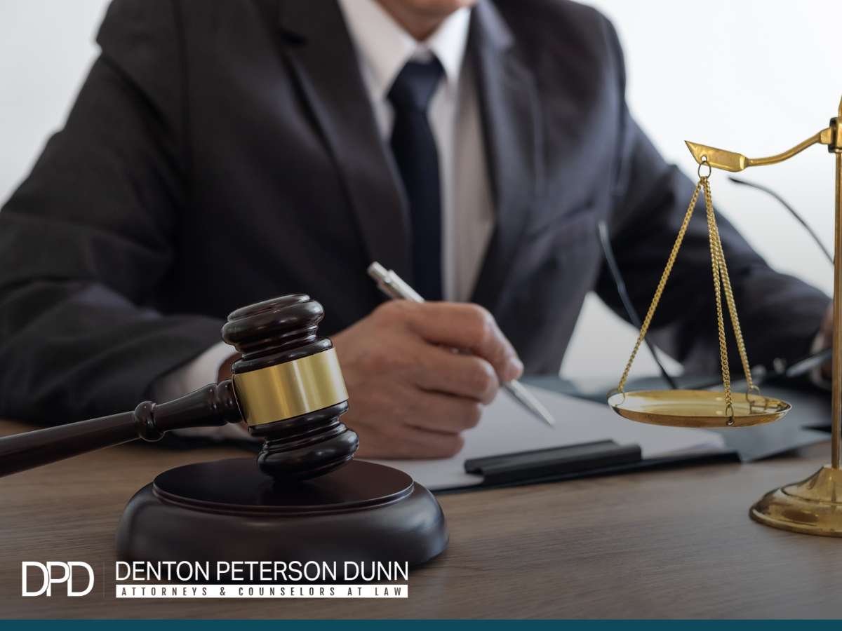 Attorney working on legal documents related to Mergers & Acquisitions at Denton Peterson Dunn law firm