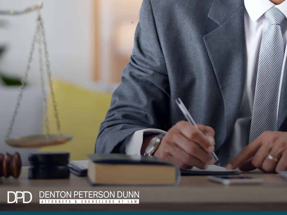 Business attorney reviewing legal documents related to embezzlement in your business