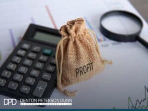 profit calculation with money bag and calculator